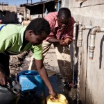 Neighbor getting water from the well.  Provides the school with indigenous funds.